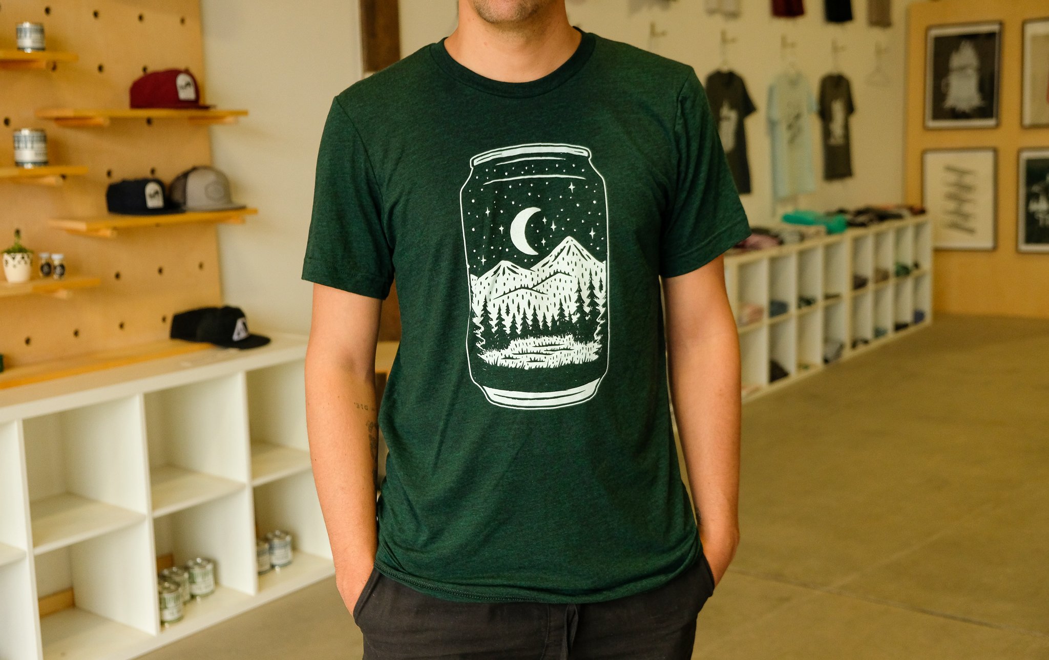 Emerald green Can Tee t-shirt featuring a night forest design, made from a soft tri-blend fabric.