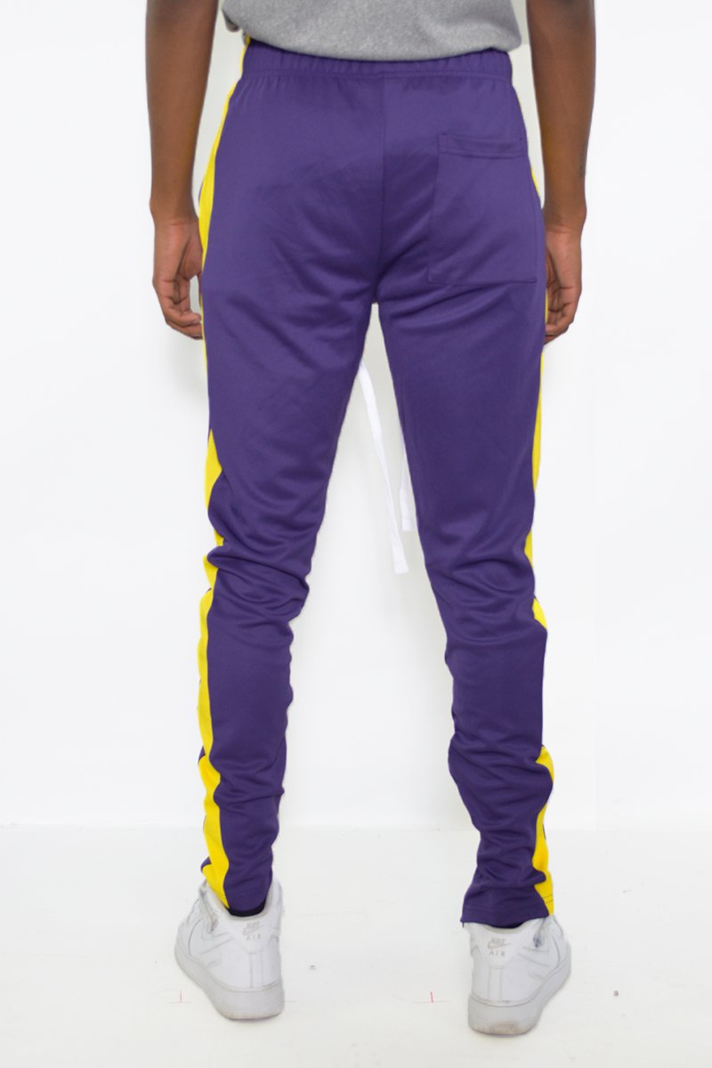 Classic Slim Fit Track Pants featuring a sleek design, single stripe detail, and hidden ankle zippers, perfect for active lifestyles.