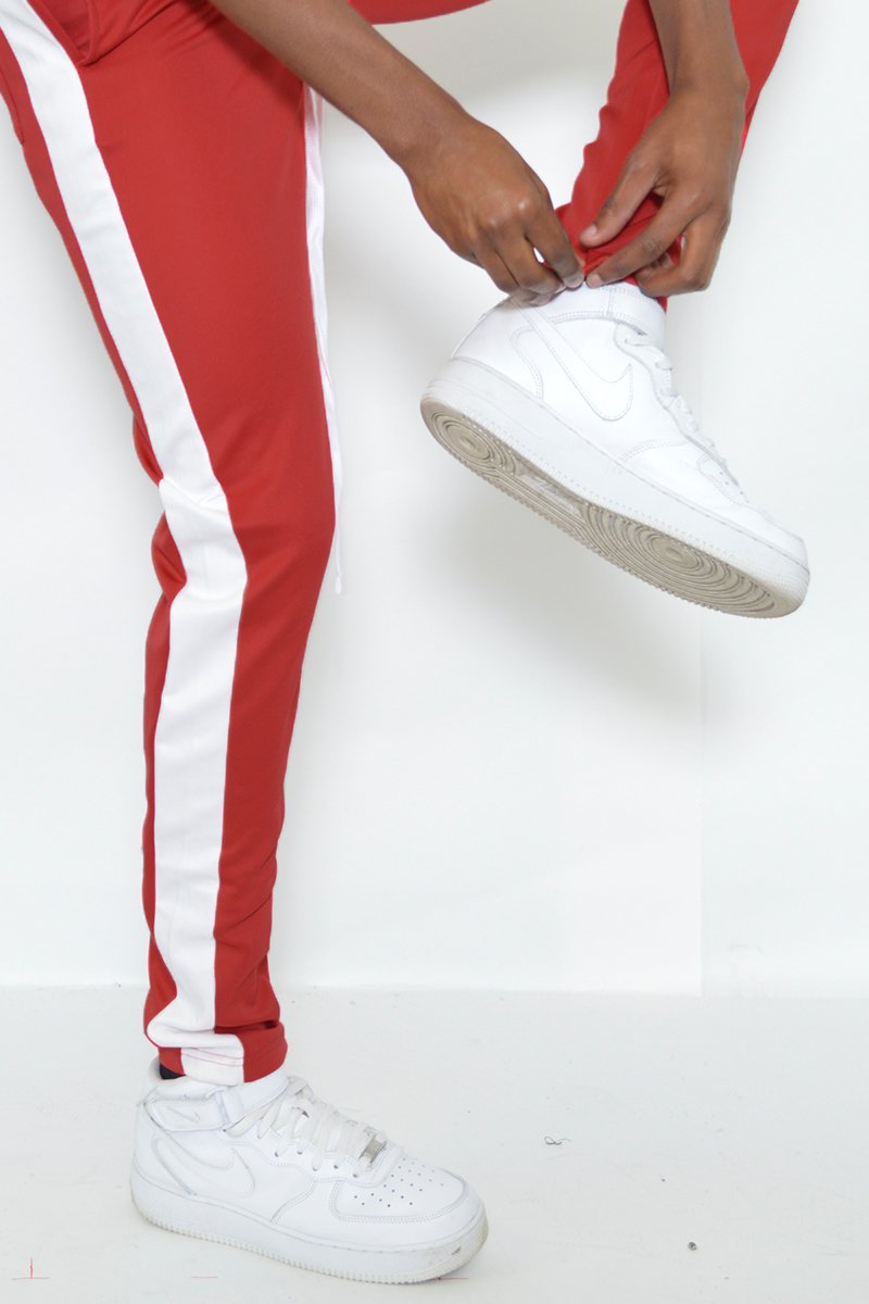 Classic slim fit track pants with single stripe detail and hidden ankle zipper, perfect for workouts and casual wear.