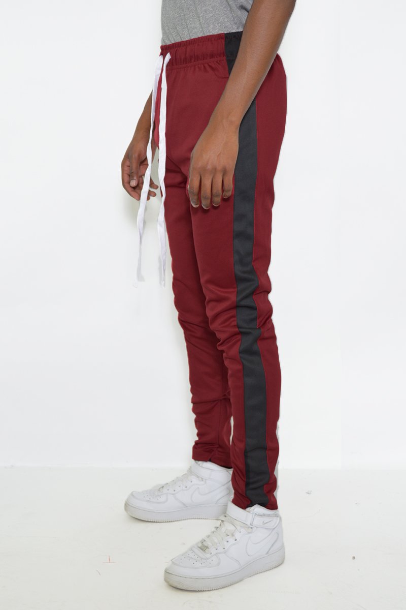 Classic Slim Fit Track Pants featuring a single stripe detail, tug-free zipper closure, and hidden ankle zipper, made from polyester and spandex.