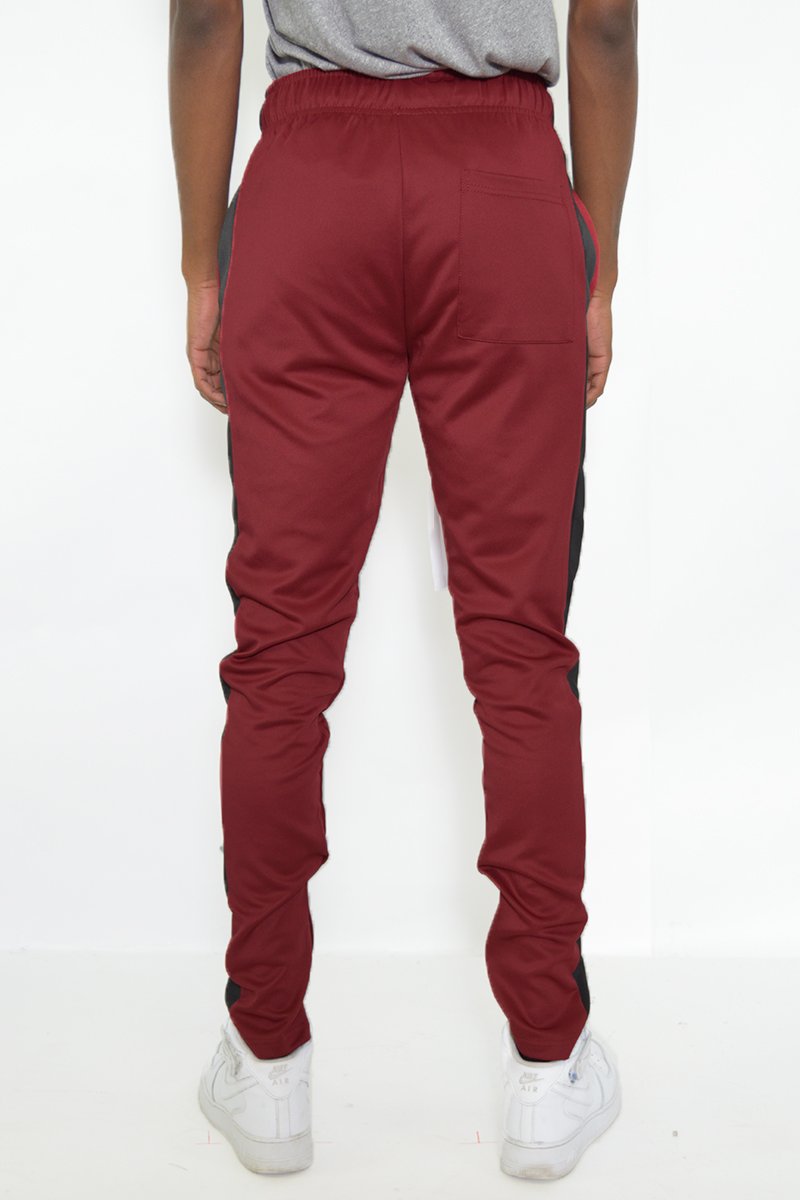 Classic Slim Fit Track Pants featuring a single stripe detail, tug-free zipper closure, and hidden ankle zipper, made from polyester and spandex.