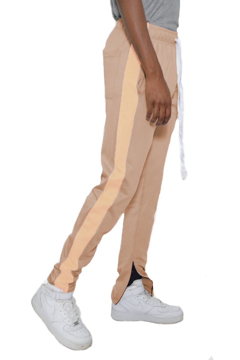 Classic Slim Fit Track Pants featuring a single stripe detail, tug-free zipper closure, and hidden ankle zipper, modeled by a 5'11 individual.