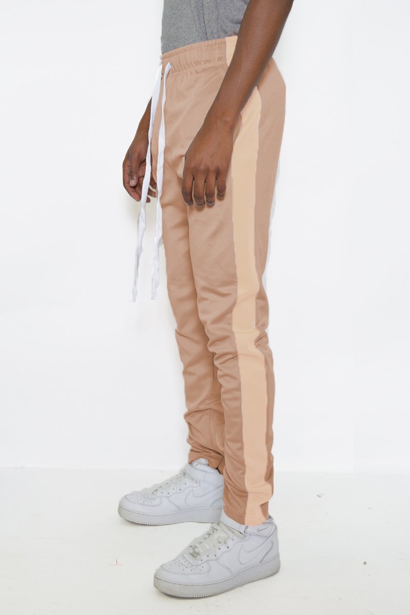 Classic Slim Fit Track Pants featuring a single stripe detail, tug-free zipper closure, and hidden ankle zipper, modeled by a 5'11 individual.