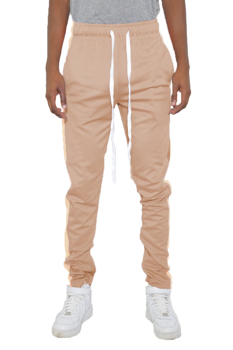 Classic Slim Fit Track Pants featuring a single stripe detail, tug-free zipper closure, and hidden ankle zipper, modeled by a 5'11 individual.