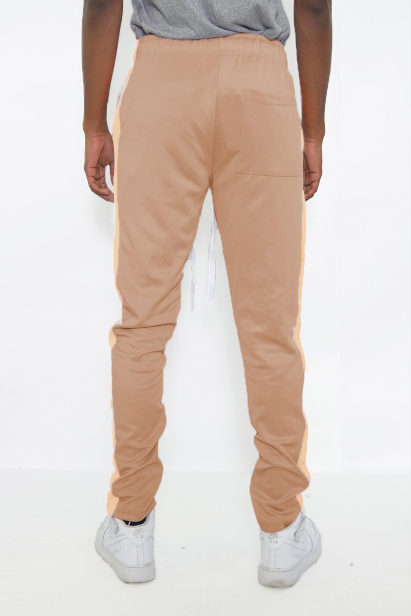 Classic Slim Fit Track Pants featuring a single stripe detail, tug-free zipper closure, and hidden ankle zipper, modeled by a 5'11 individual.