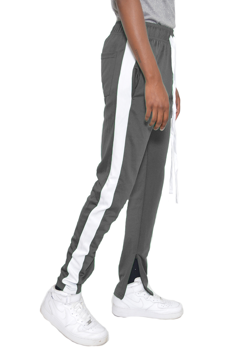 Classic Slim Fit Track Pants featuring a single stripe detail and hidden ankle zipper, modeled by a person standing at 5'11 wearing a Medium size.