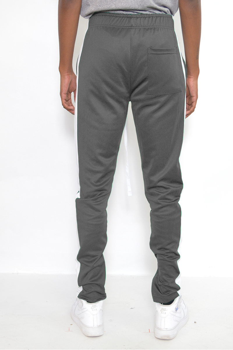 Classic Slim Fit Track Pants featuring a single stripe detail and hidden ankle zipper, modeled by a person standing at 5'11 wearing a Medium size.