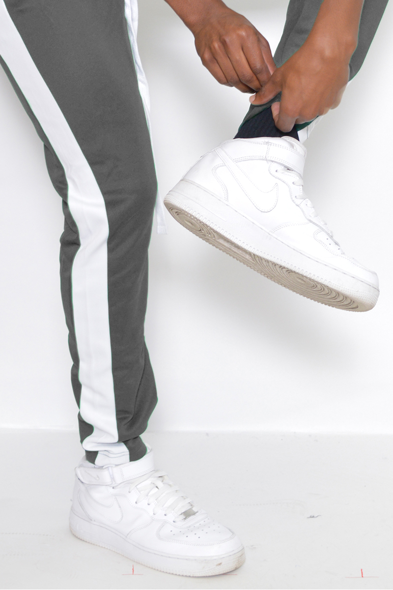 Classic Slim Fit Track Pants featuring a single stripe detail and hidden ankle zipper, modeled by a person standing at 5'11 wearing a Medium size.