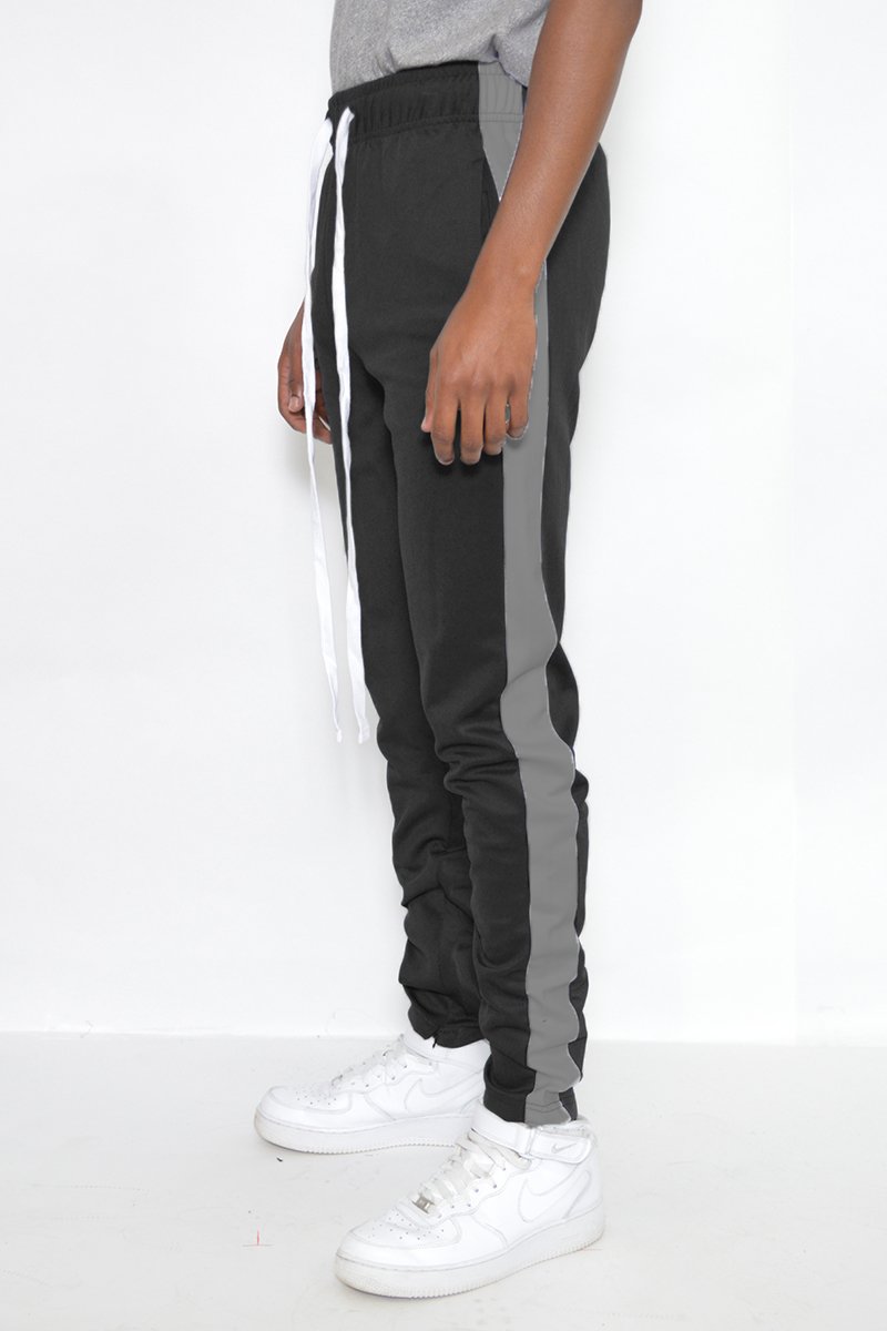 Classic Slim Fit Track Pants featuring a single stripe detail, tug-free zipper closure, and hidden ankle zipper, modeled by a person standing at 5'11.