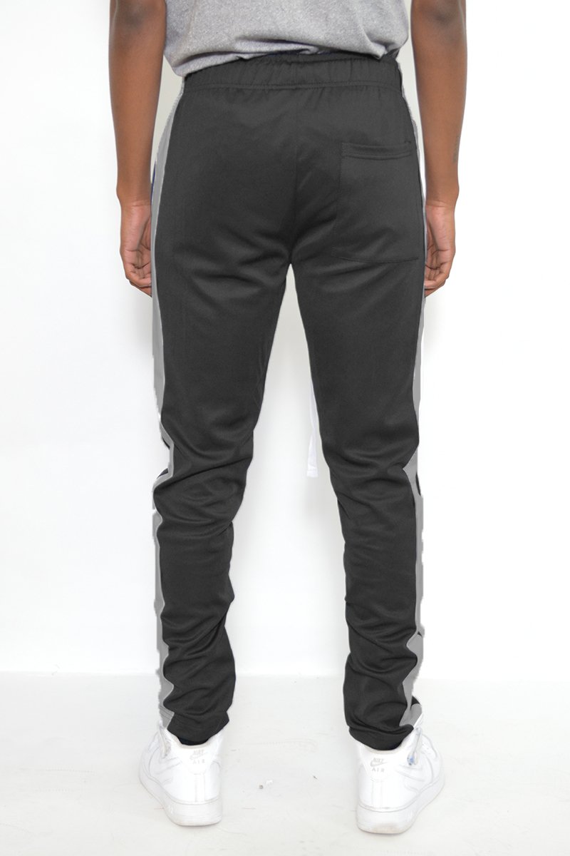 Classic Slim Fit Track Pants featuring a single stripe detail, tug-free zipper closure, and hidden ankle zipper, modeled by a person standing at 5'11.