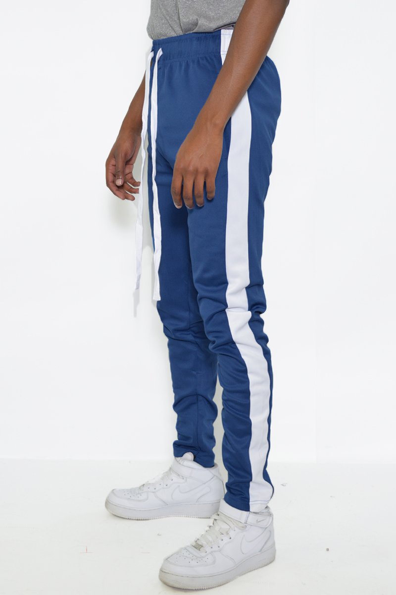 Classic Slim Fit Track Pants featuring a single stripe detail and hidden ankle zippers, modeled by a person standing at 5'11 wearing a Medium size.