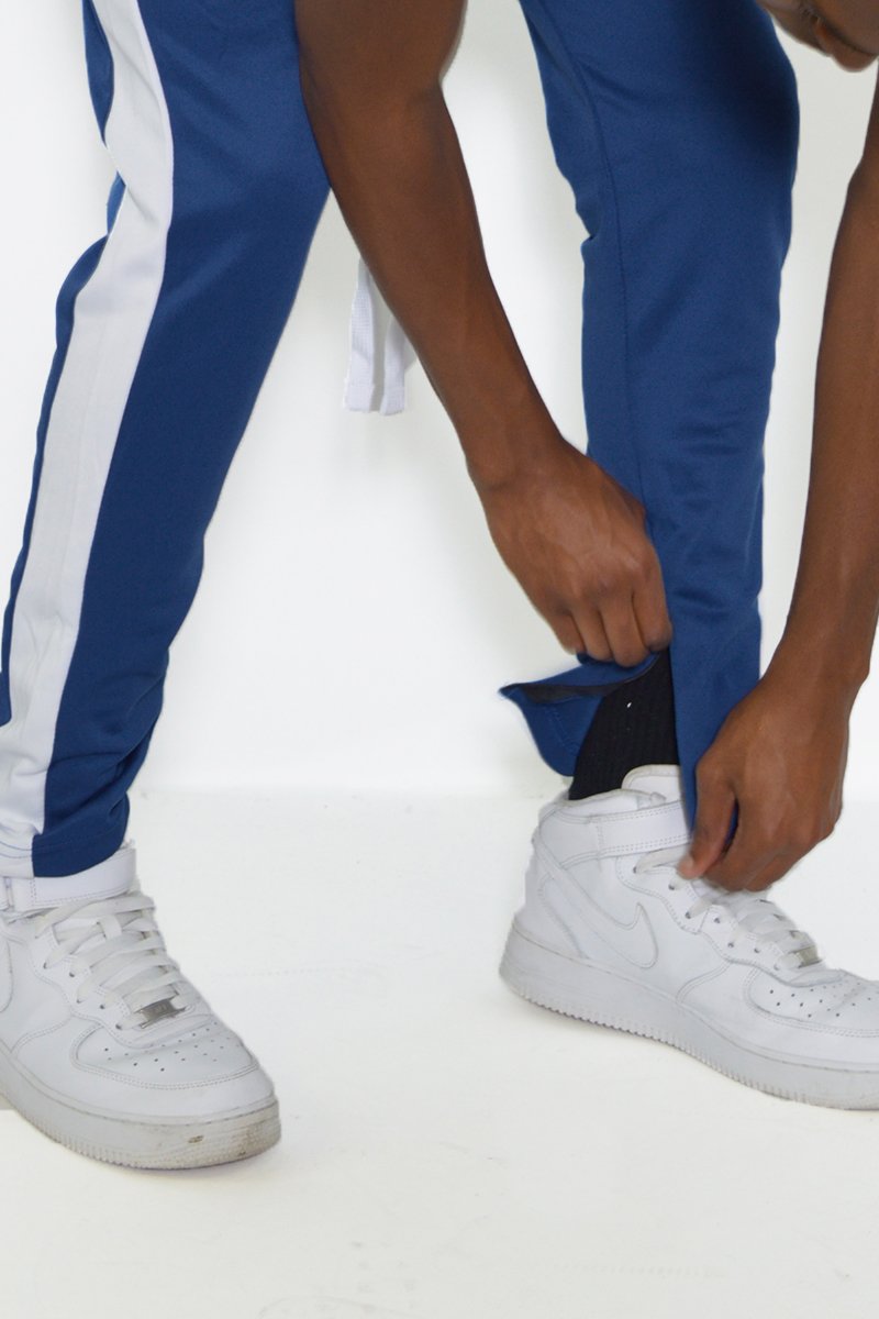 Classic Slim Fit Track Pants featuring a single stripe detail and hidden ankle zippers, modeled by a person standing at 5'11 wearing a Medium size.