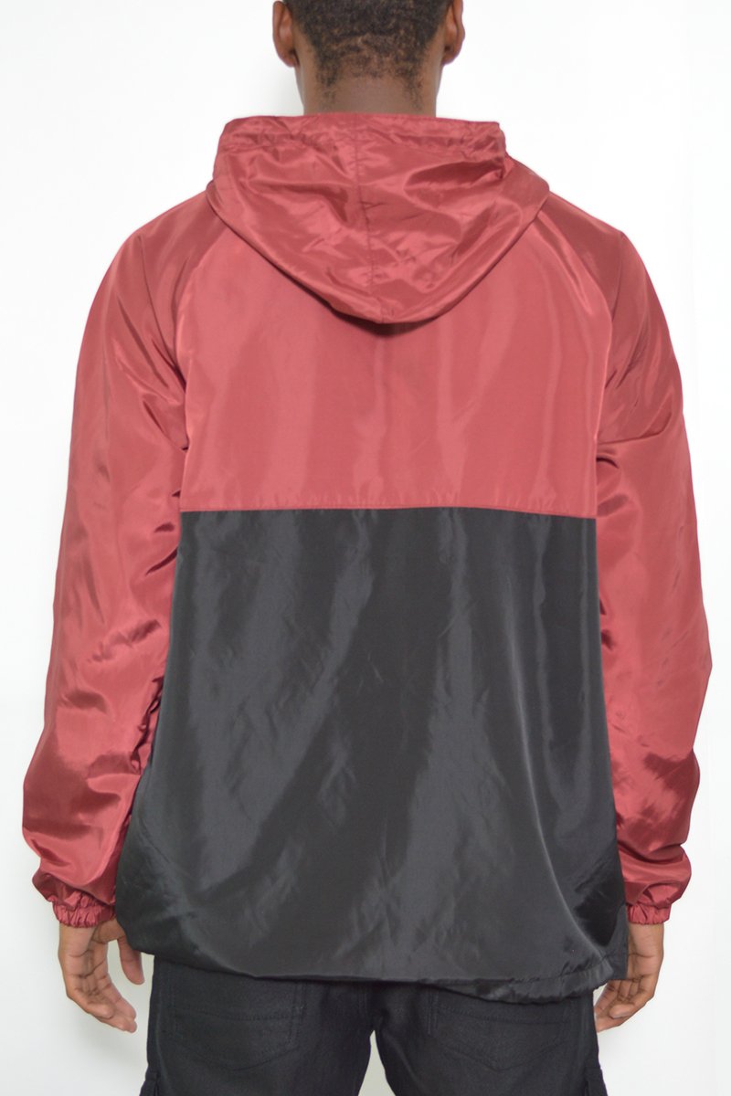 Color Block Anorak Jacket featuring a vibrant design with flap pockets and quarter zip closure, modeled by a tall individual.