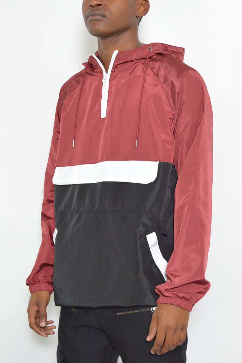 Color Block Anorak Jacket featuring a vibrant design with flap pockets and quarter zip closure, modeled by a tall individual.