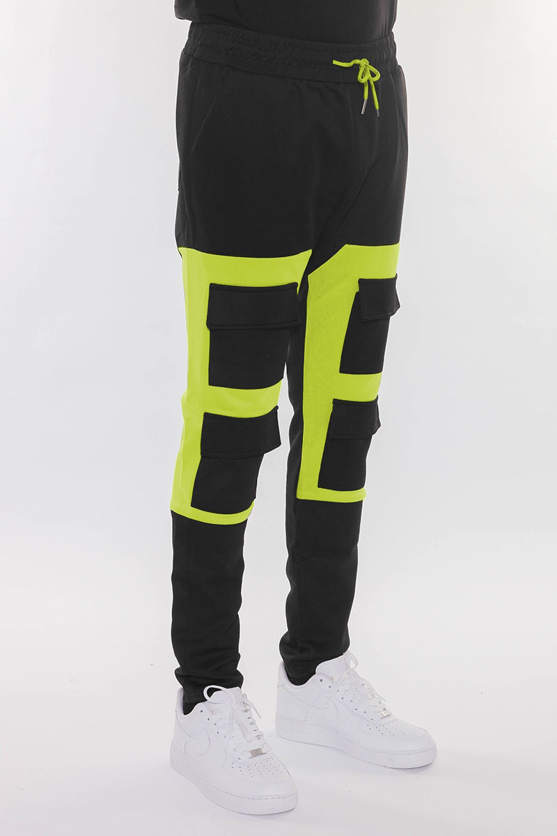 Color Block Cargo Track Pants featuring Velcro closure pouch pockets and ankle zippers, styled on a model.