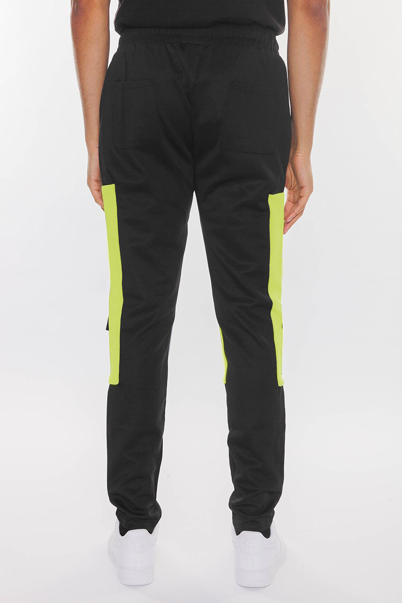 Color Block Cargo Track Pants featuring Velcro closure pouch pockets and ankle zippers, styled on a model.