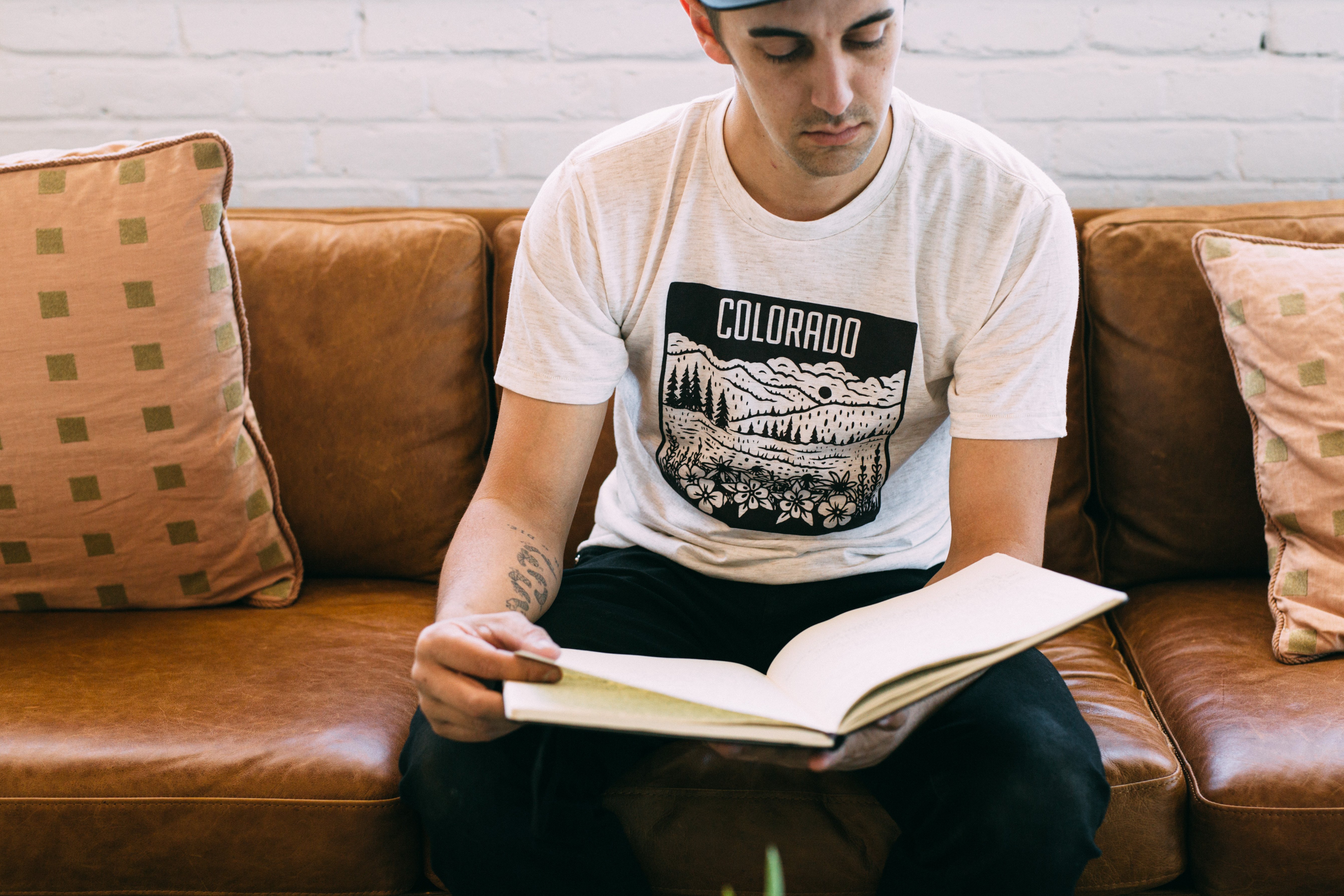 Colorado Mountain Tee in oatmeal color featuring maroon screen print of Rocky Mountain design with wildflowers.