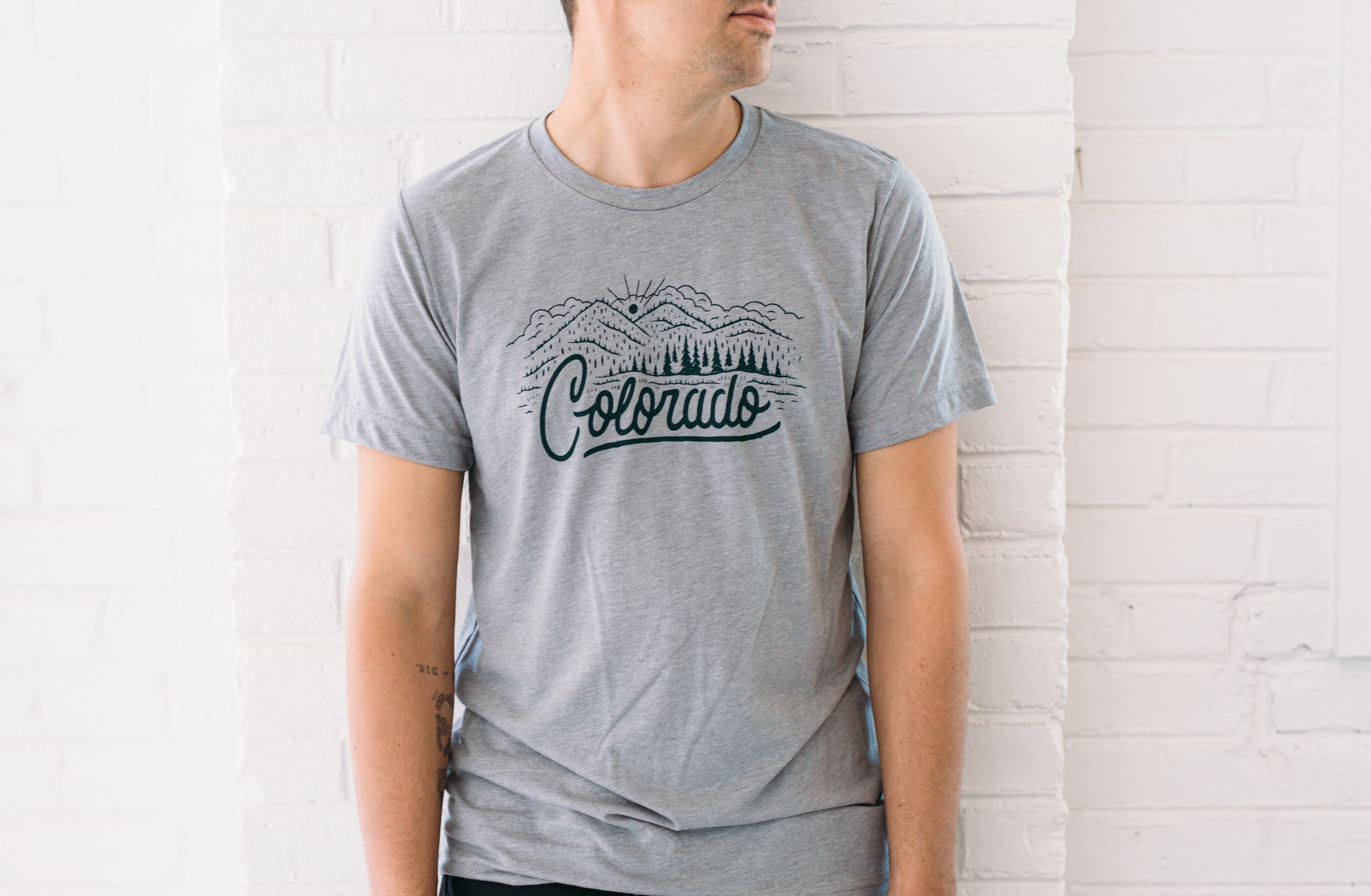 Athletic gray Colorado Tee featuring a forest green hand-lettered design of a Colorado landscape.