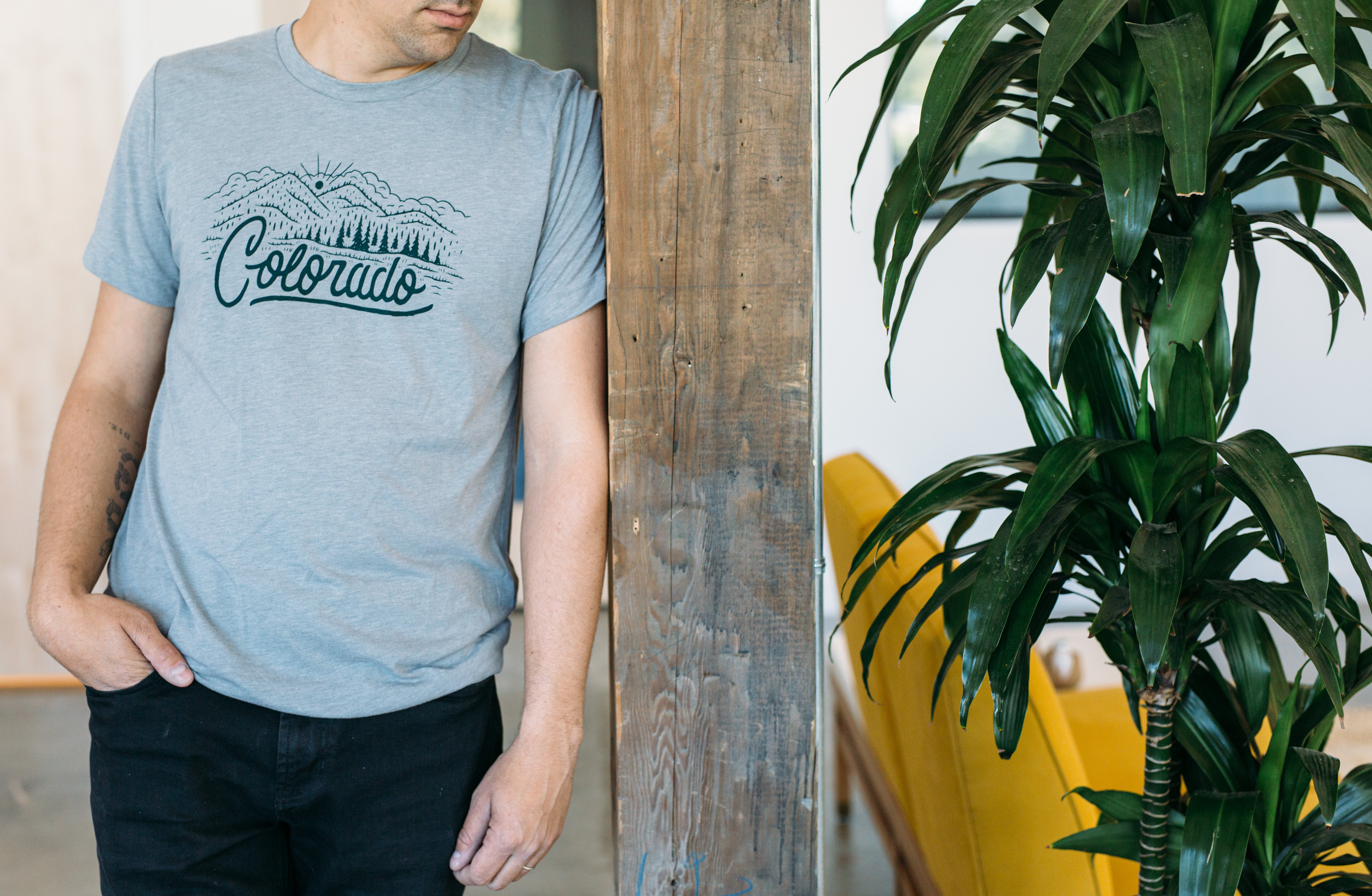 Athletic gray Colorado Tee featuring a forest green hand-lettered design of a Colorado landscape.