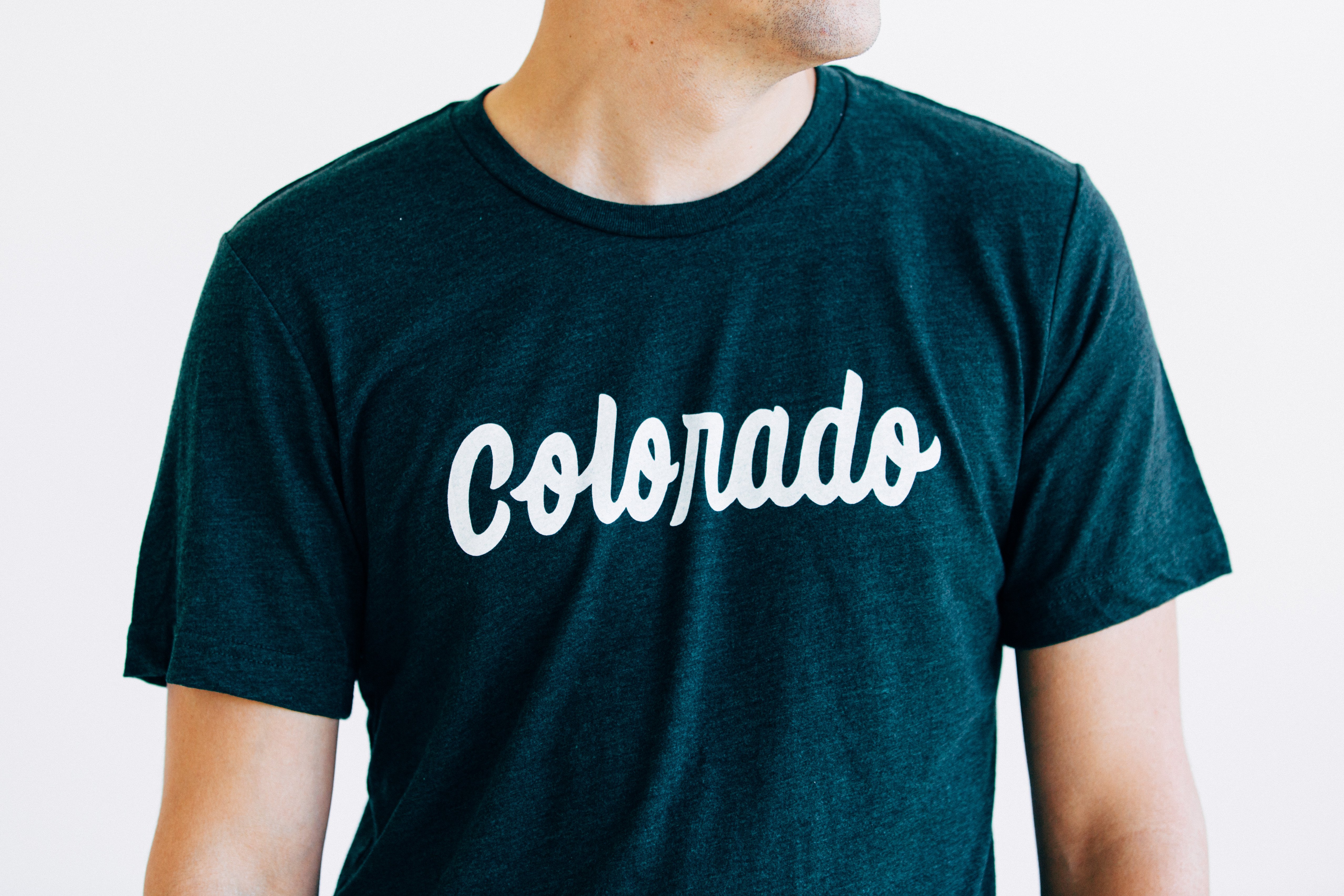 Emerald green Colorado Tee featuring hand lettering design, made from soft tri-blend fabric.