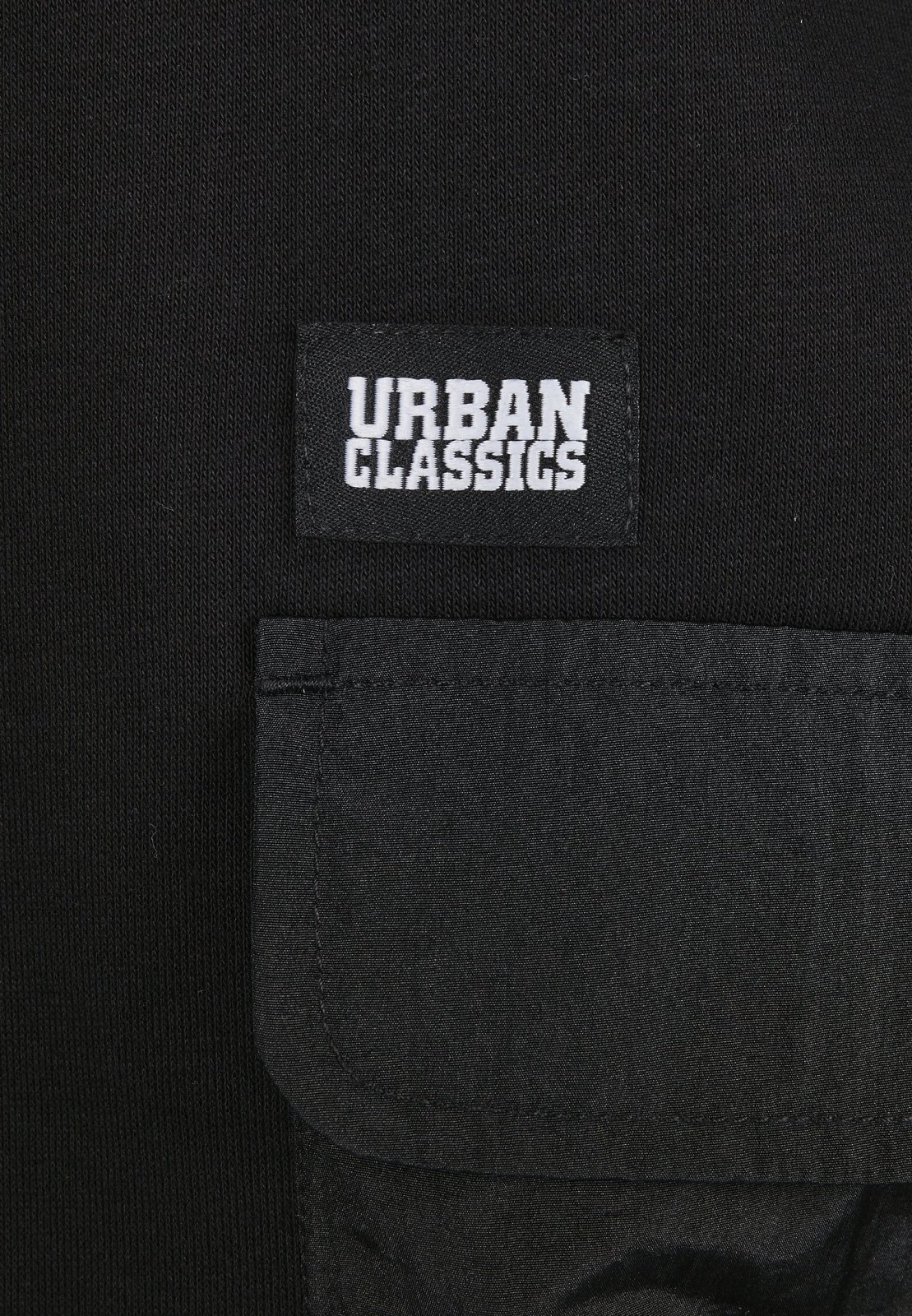 Men's Commuter Hoodie featuring three flap pockets, Urban Classics logo, and ribbed cuffs in soft Terry fabric.