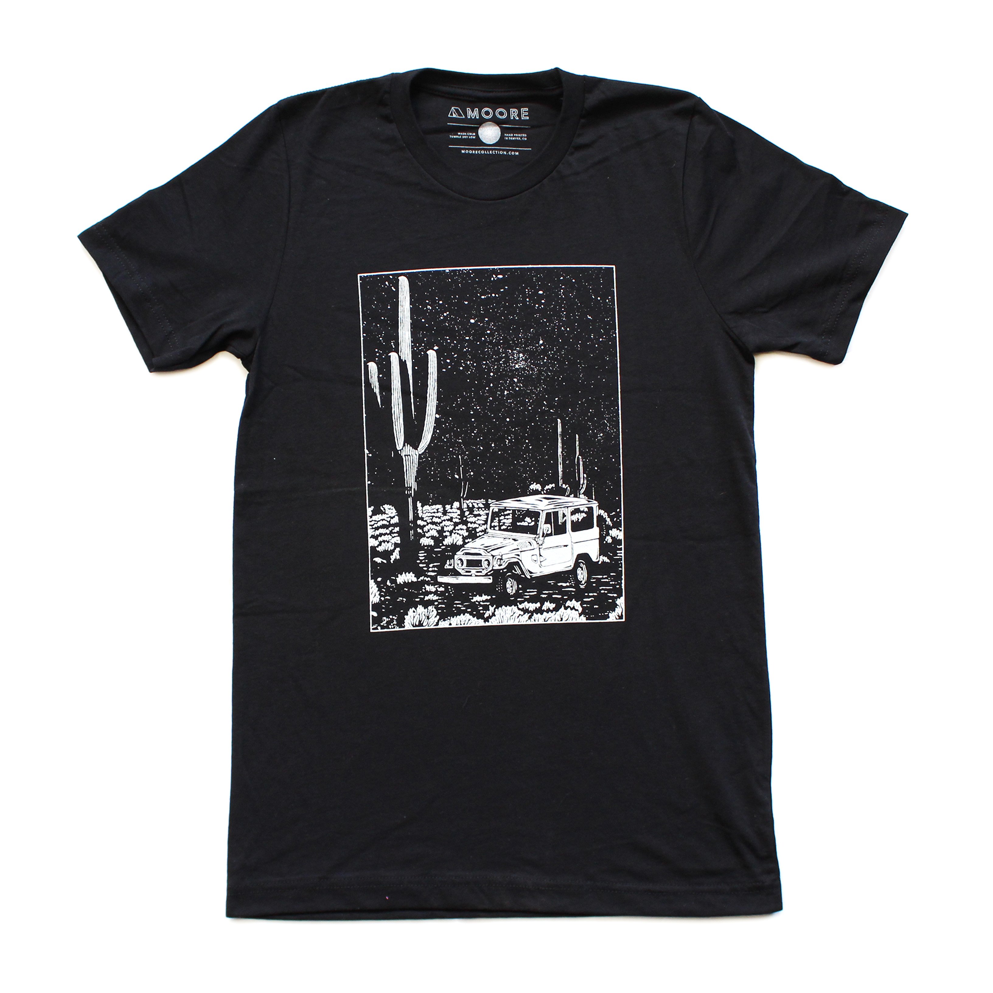 Black Desert Cruiser Tee featuring white water-based ink design, made from 100% ringspun cotton, showcasing a unique desert-inspired graphic.