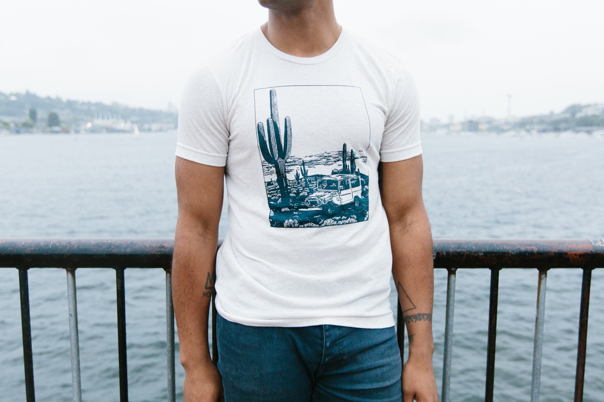 Desert Cruiser Tee in oatmeal color featuring a navy screen print design, showcasing a soft tri-blend fabric perfect for outdoor adventures.