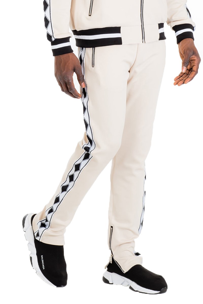 Diamond Lineage Track Pants featuring a slim fit design, ankle zippers, and multiple pockets, made from a durable polyester and spandex blend.