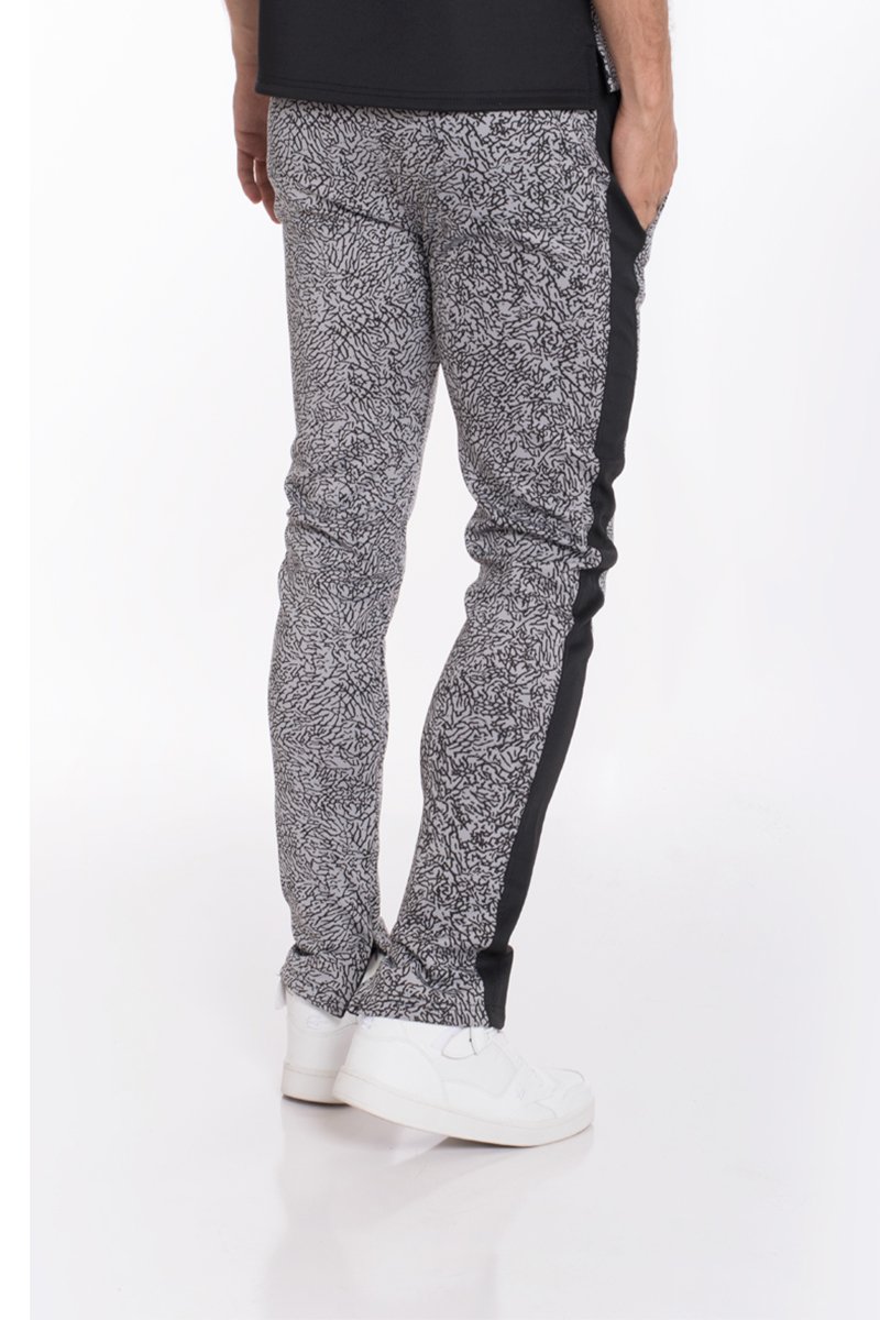 Black elephant print pants featuring a two-tone color block design and ankle zippers, perfect for casual wear.