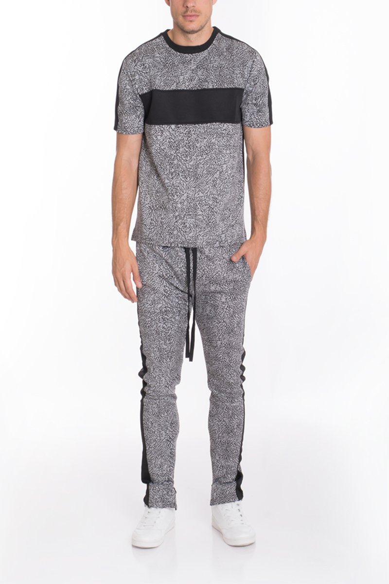 Black elephant print pants featuring a two-tone color block design and ankle zippers, perfect for casual wear.