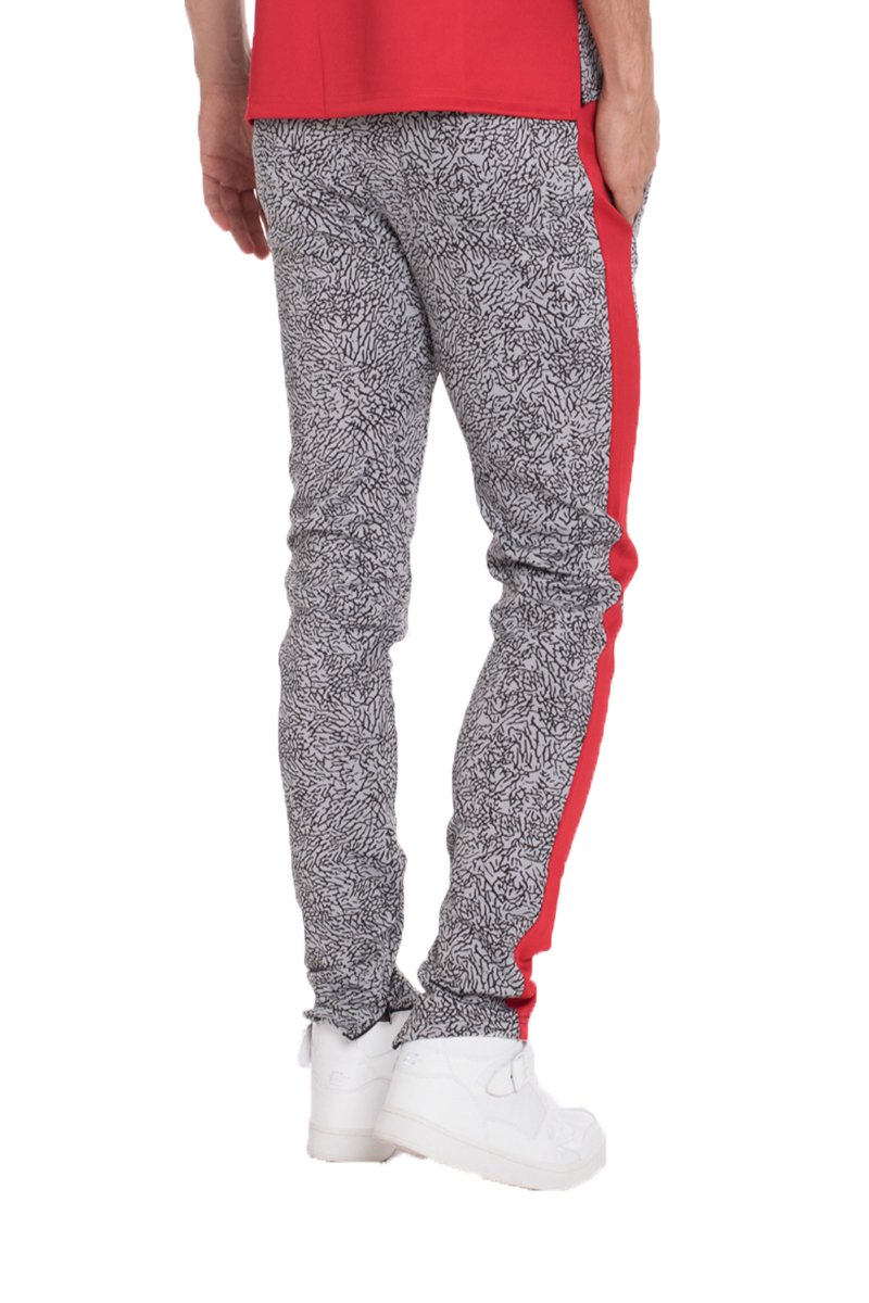 Red elephant print pants featuring a two-tone color block design, ankle zippers, and lightweight fabric, perfect for casual wear.