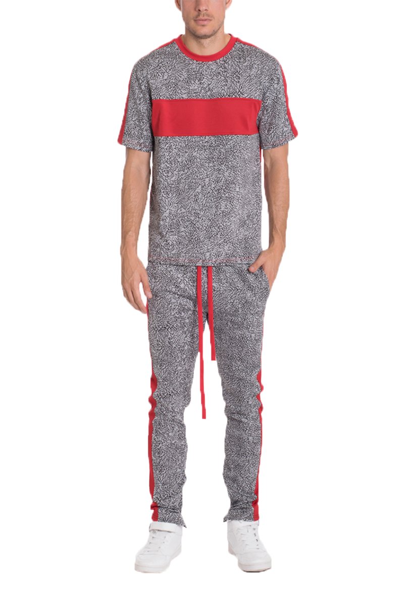 Red elephant print pants featuring a two-tone color block design, ankle zippers, and lightweight fabric, perfect for casual wear.