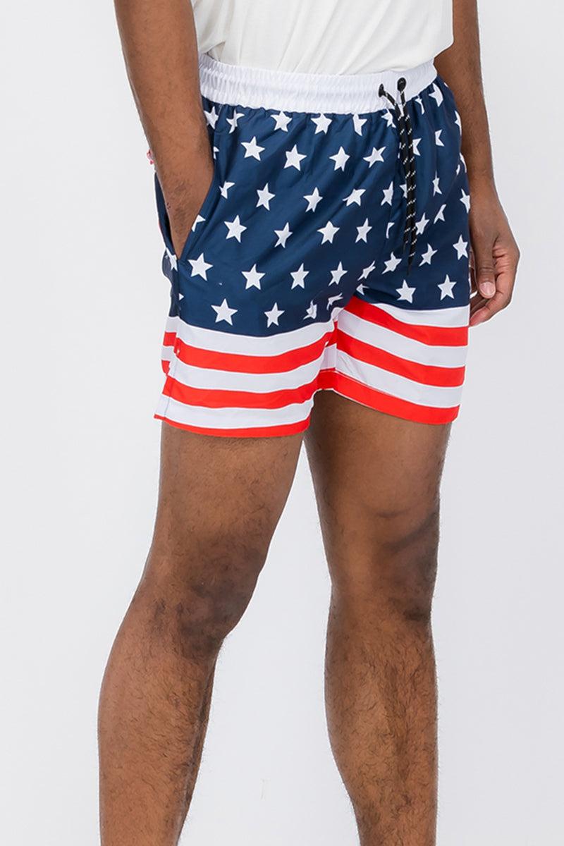 A pair of vibrant flag print swim shorts featuring a regular fit and mesh lining, ideal for beach and pool activities.