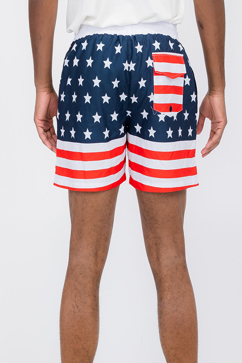 A pair of vibrant flag print swim shorts featuring a regular fit and mesh lining, ideal for beach and pool activities.