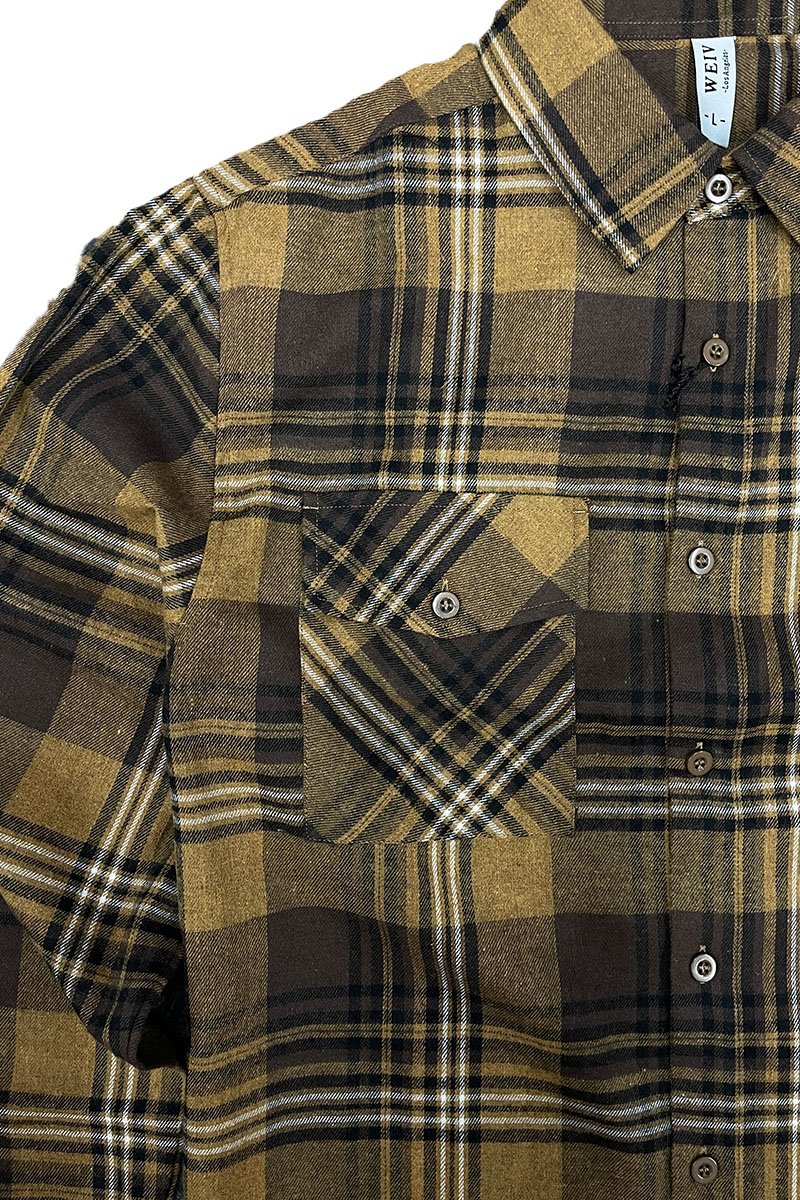 A cozy checkered flannel shirt with long sleeves, brushed on both sides for a soft and fluffy feel, suitable for unisex wear.