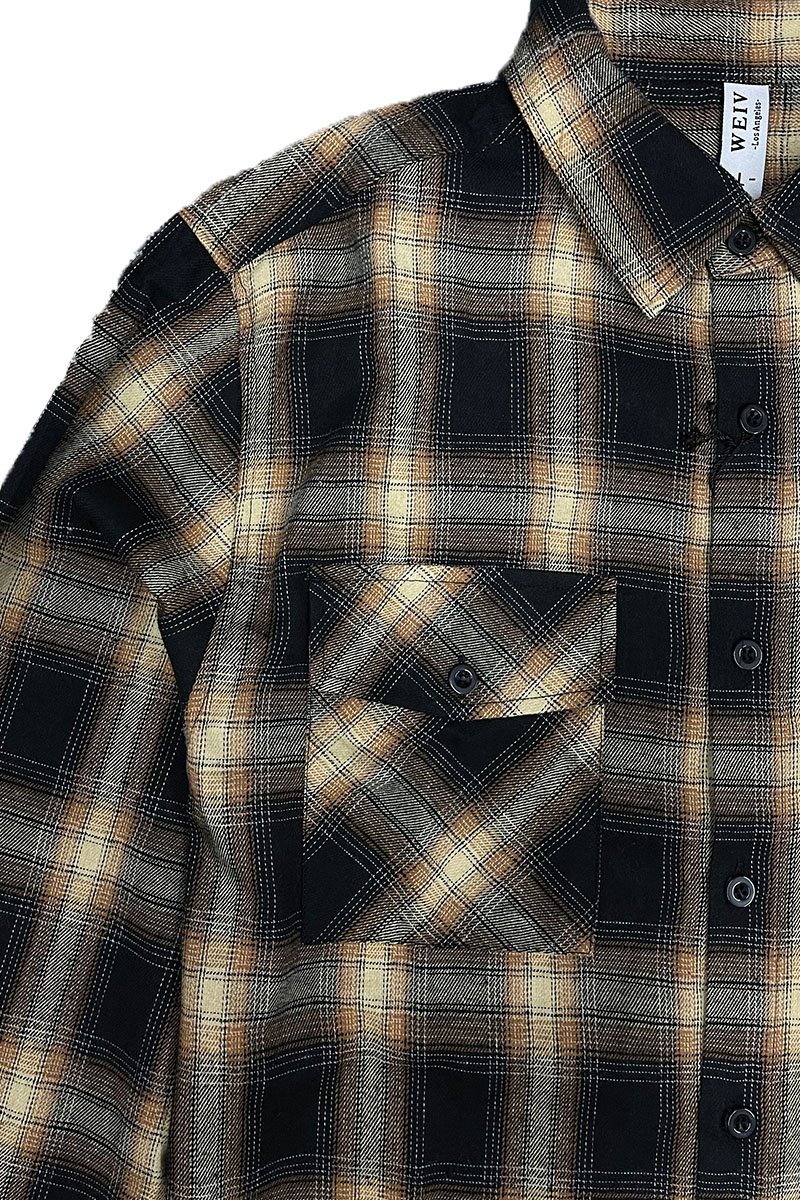 A cozy checkered flannel shirt with long sleeves, brushed on both sides for softness, displayed on a hanger.