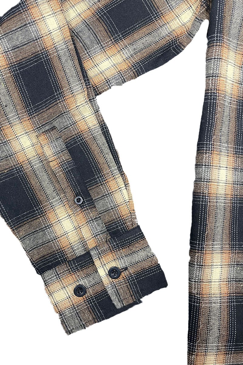 A cozy checkered flannel shirt with long sleeves, brushed on both sides for softness, displayed on a hanger.