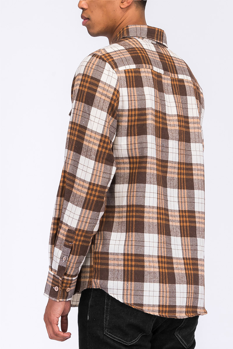 A stylish checkered long sleeve flannel shirt featuring a regular fit, chest pockets, and a curved hem, perfect for casual wear.