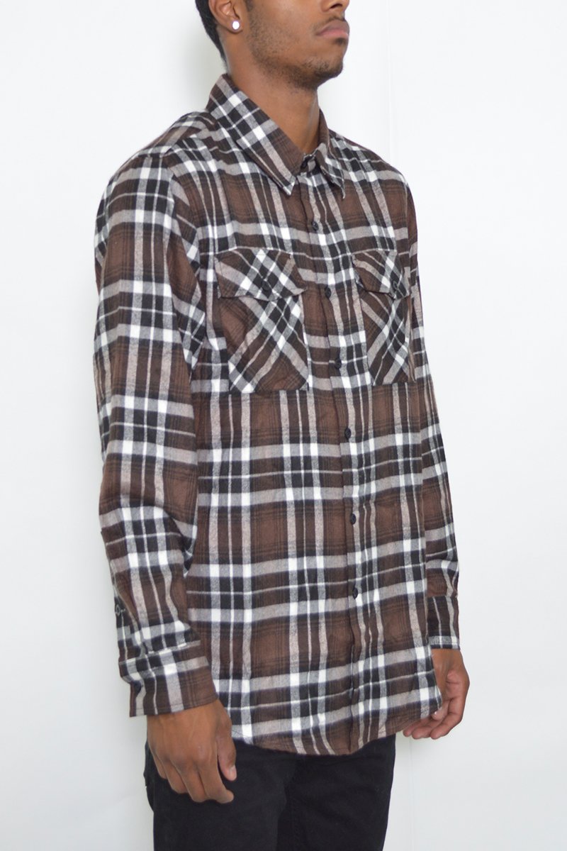 A model wearing a stylish flannel shirt made of 100% polyester, showcasing its true-to-size fit and comfortable design.