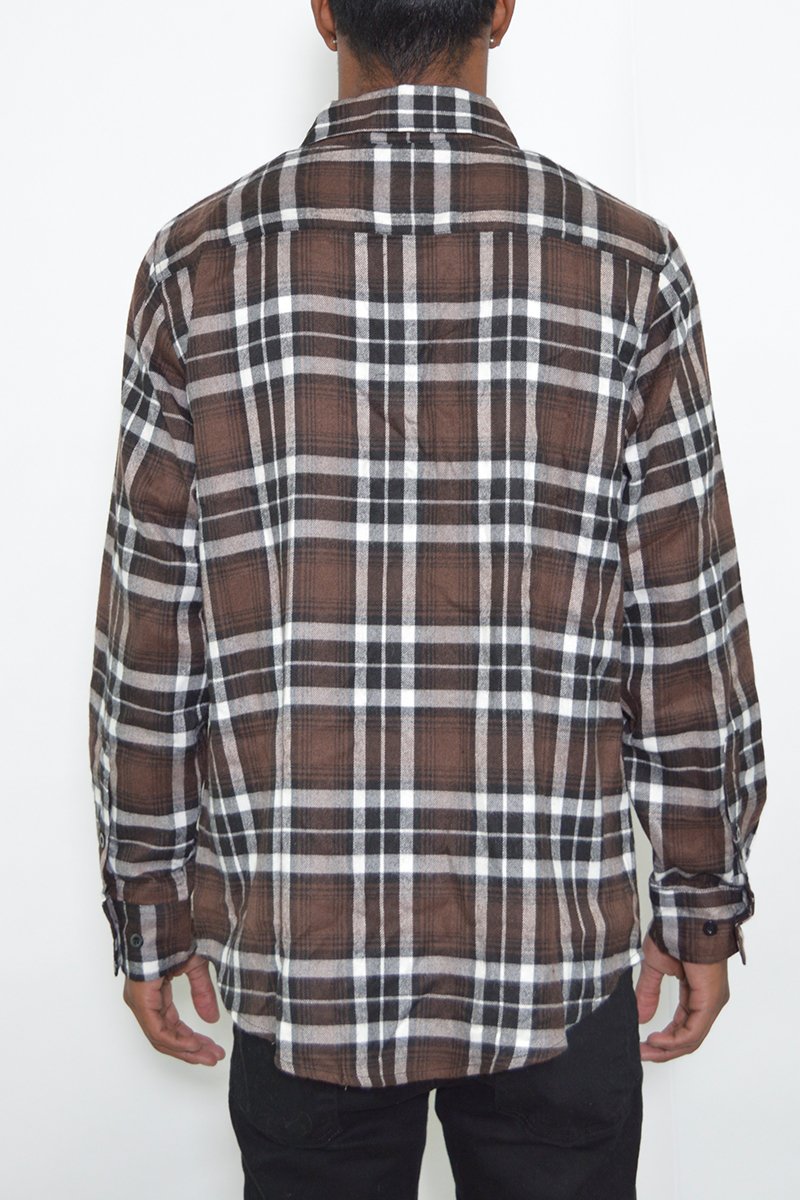 A model wearing a stylish flannel shirt made of 100% polyester, showcasing its true-to-size fit and comfortable design.