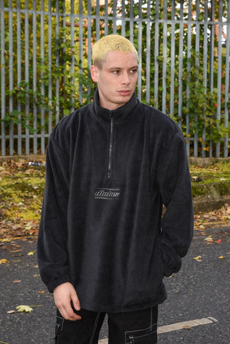 Black fleece with DBDNS Futuristic Logo Embroidery, featuring a 1/4 zip and two front pockets, showcasing a relaxed fit.