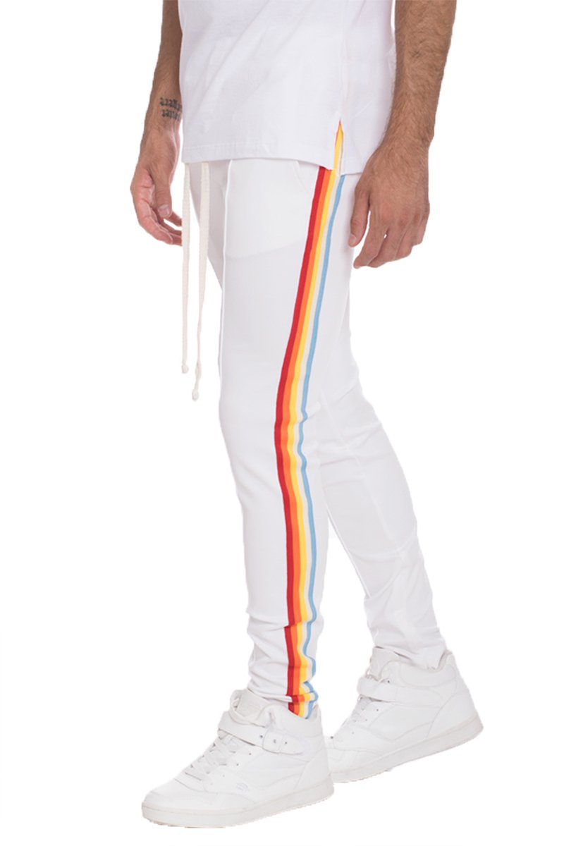 A stylish FULL RAINBOW SET in White, featuring a vibrant rainbow design, made from a soft polyester and spandex blend, modeled by a tall individual.