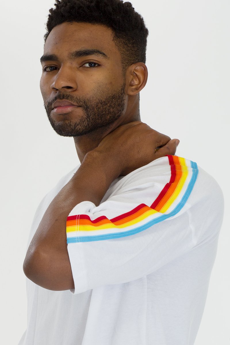 A stylish FULL RAINBOW SET in White, featuring a vibrant rainbow design, made from a soft polyester and spandex blend, modeled by a tall individual.