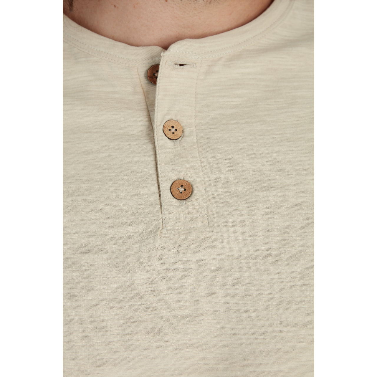 Gabe Solid Slub Henley in sand color, featuring a three-button placket and short sleeves, made from 100% cotton.