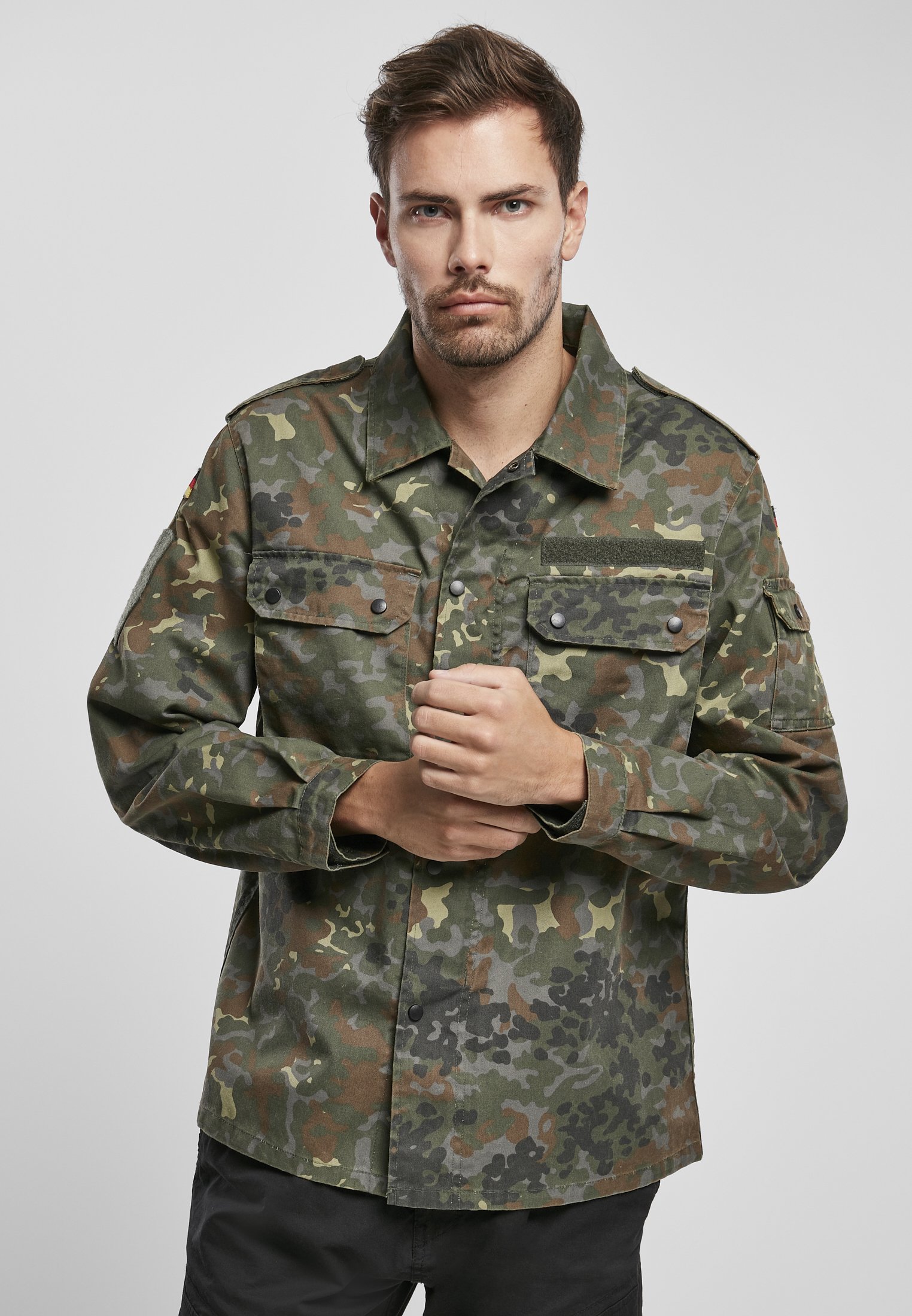 German Forces Military Field Blouse featuring durable fabric, chest pockets, and national emblems.