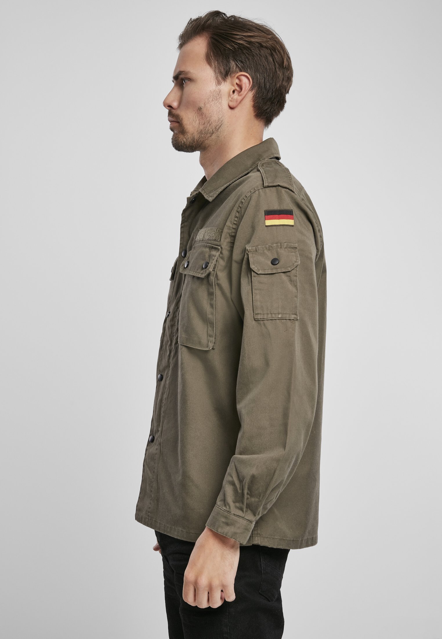 German Forces Military Field Blouse featuring durable fabric, chest pockets, and national emblems.