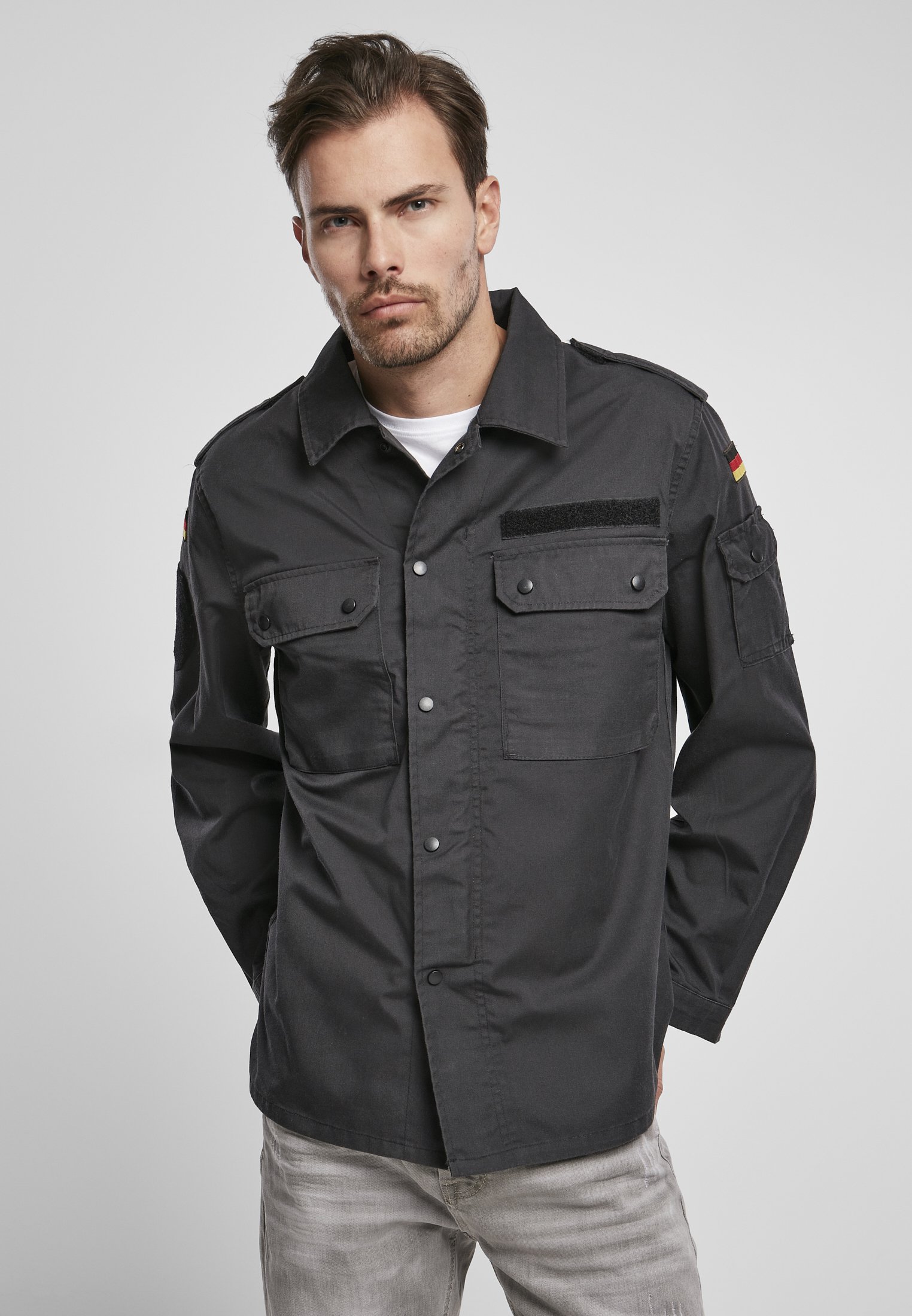 German Forces Military Field Blouse featuring durable fabric, chest pockets, and national emblems.