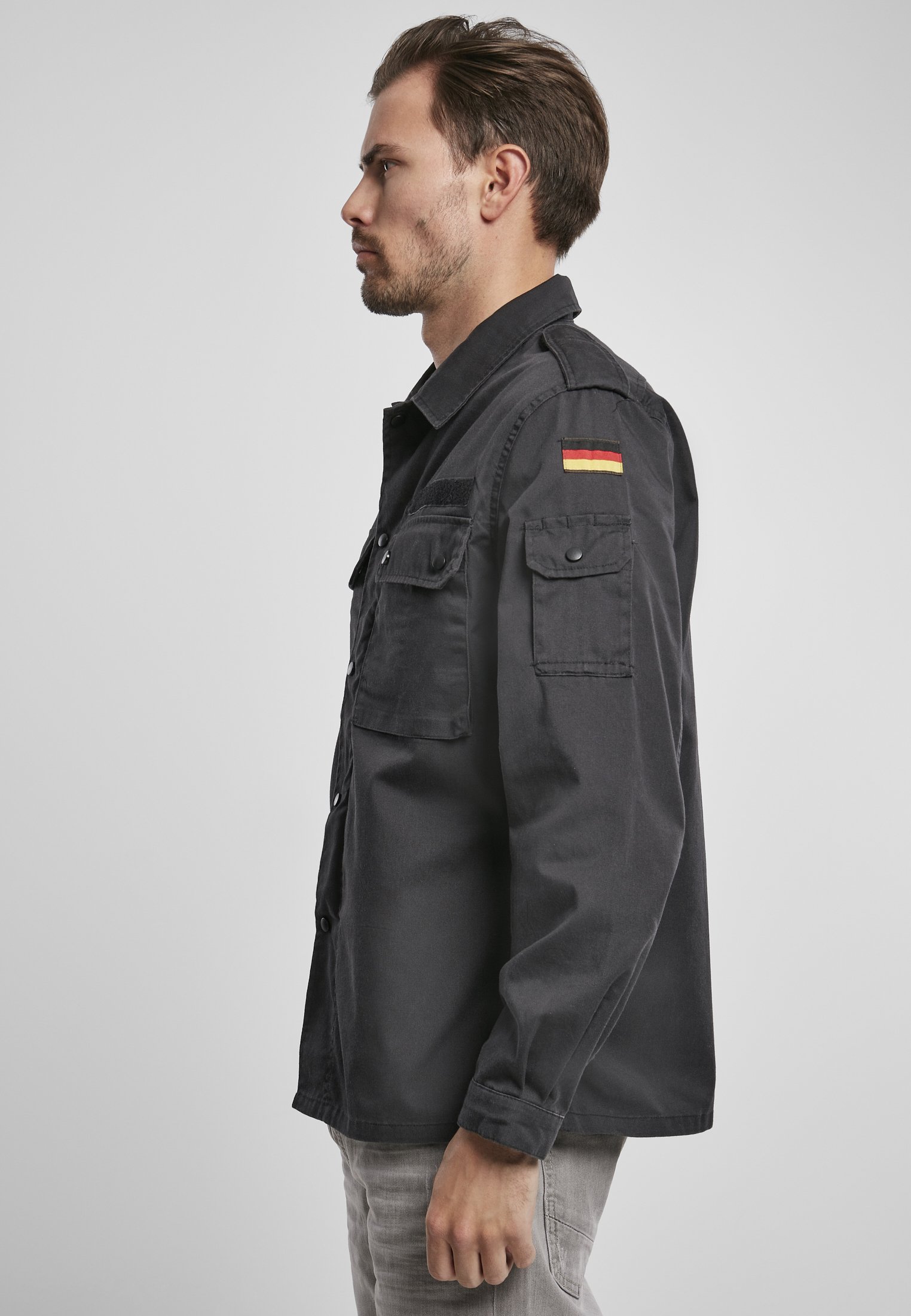 German Forces Military Field Blouse featuring durable fabric, chest pockets, and national emblems.