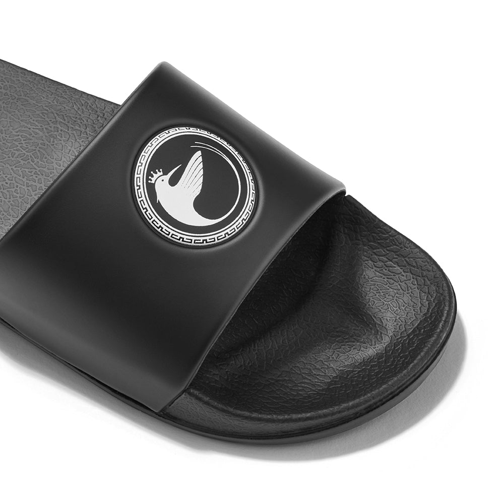 Black God Bird slip-on unisex sliders featuring a wide strap and contoured footbed with a debossed logo.