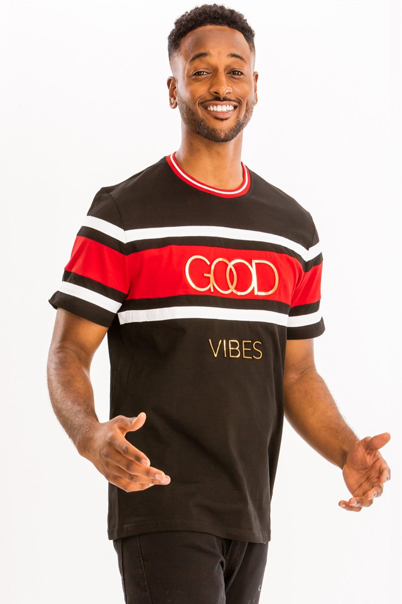 A model wearing the GOOD VIBES TEE, showcasing its relaxed fit and soft cotton fabric in a casual setting.